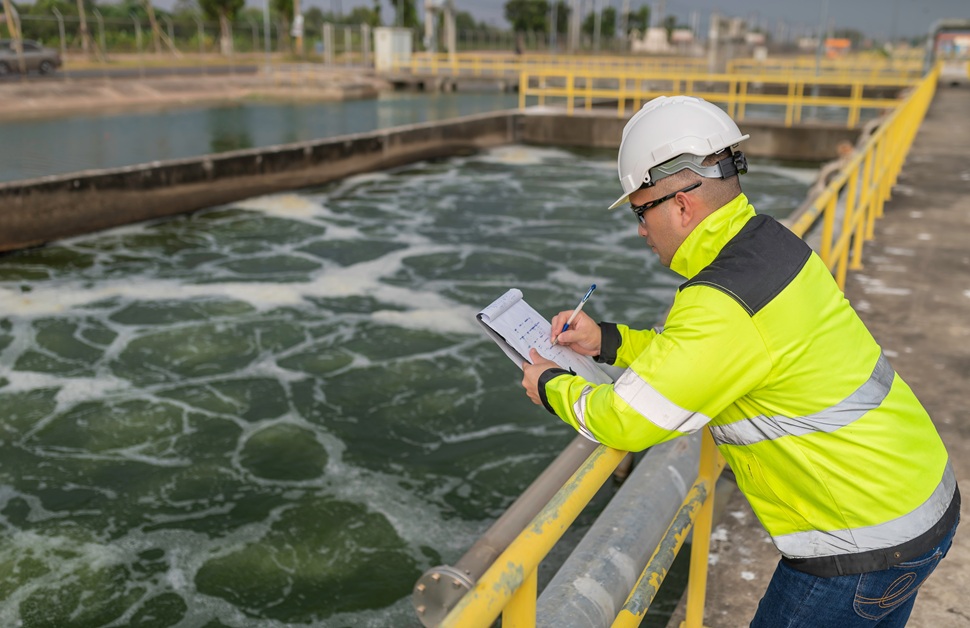 A geo-environmental consultant making notes during contaminated land risk management